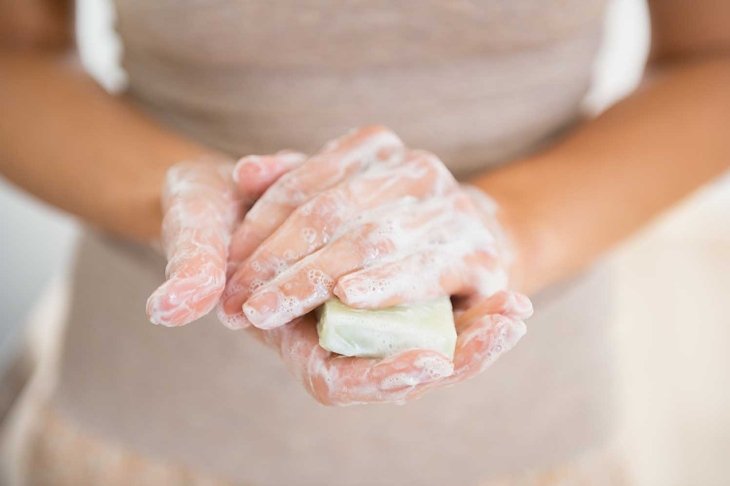 Closeup on young woman hands with soap bar